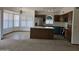 Open kitchen features an island, stainless steel appliances, and ample natural light from many windows at 3601 E Taro Ln, Phoenix, AZ 85050