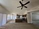 Open-concept kitchen and living area showcasing the kitchen island and stainless steel refrigerator at 3601 E Taro Ln, Phoenix, AZ 85050