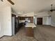 Bright kitchen with stainless steel appliances, an island, and arched doorways at 3601 E Taro Ln, Phoenix, AZ 85050