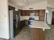 Well-lit kitchen features an island, stainless steel appliances, and dark wood cabinetry at 3601 E Taro Ln, Phoenix, AZ 85050