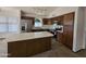This is a cozy kitchen with dark brown cabinets, an island, and stainless steel appliances at 3601 E Taro Ln, Phoenix, AZ 85050