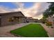 Inviting backyard with a patch of green lawn and low maintenance landscaping at 3604 W Calle Lejos --, Glendale, AZ 85310