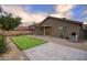 Spacious backyard with artificial turf, a built-in grill, and a paved patio area at 3604 W Calle Lejos --, Glendale, AZ 85310