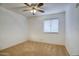 Cozy bedroom featuring a ceiling fan and a window with bright natural light at 3604 W Calle Lejos --, Glendale, AZ 85310