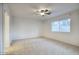 A bright, spacious bedroom featuring neutral carpet and a ceiling fan at 3604 W Calle Lejos --, Glendale, AZ 85310