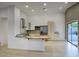 Bright open kitchen featuring stainless steel appliances, light cabinetry, and access to the backyard at 3604 W Calle Lejos --, Glendale, AZ 85310