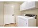 Functional laundry room with washer, dryer, and white cabinets for storage at 3604 W Calle Lejos --, Glendale, AZ 85310