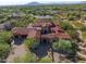 Expansive estate with a red tile roof, desert landscaping, and a three-car garage in a private community at 37440 N 104Th Pl, Scottsdale, AZ 85262