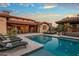This spacious backyard features a large pool, spa, covered patio with seating, and lush desert landscaping at 37440 N 104Th Pl, Scottsdale, AZ 85262