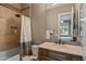 Well-lit bathroom featuring a shower and tub combo, vanity with sink, and neutral color palette at 37440 N 104Th Pl, Scottsdale, AZ 85262
