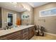 Bathroom with double sinks, granite countertops, custom cabinetry and natural light at 37440 N 104Th Pl, Scottsdale, AZ 85262