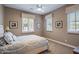 Cozy bedroom with neutral walls, carpet flooring, and natural light coming through two windows at 37440 N 104Th Pl, Scottsdale, AZ 85262
