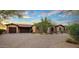 Beautiful house with a desert landscape, brick driveway, and a spacious three-car garage at 37440 N 104Th Pl, Scottsdale, AZ 85262