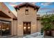 Beautifully detailed front entrance with iron double doors and custom lighting at 37440 N 104Th Pl, Scottsdale, AZ 85262