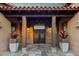 Covered entrance with stone columns, tile flooring, and double doors at 37440 N 104Th Pl, Scottsdale, AZ 85262