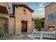 Charming front entrance has an ornate door, stucco exterior, and private courtyard with fireplace and outdoor seating at 37440 N 104Th Pl, Scottsdale, AZ 85262