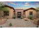Stunning front exterior with brick accents, desert landscaping, and a paved walkway at 37440 N 104Th Pl, Scottsdale, AZ 85262