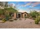 Charming single-story home with a brick-paved driveway and lush desert landscaping at 37440 N 104Th Pl, Scottsdale, AZ 85262
