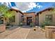 Charming home featuring a beautifully landscaped front yard, brick accents, and a welcoming double door entrance at 37440 N 104Th Pl, Scottsdale, AZ 85262