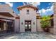 Elegant facade showcasing stone accents, stylish lighting fixtures, and a striking entrance with a custom double door at 37440 N 104Th Pl, Scottsdale, AZ 85262