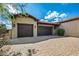 Attractive single Gathering home featuring a two car garage with wood doors and a brick paver driveway at 37440 N 104Th Pl, Scottsdale, AZ 85262