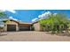 Attractive single Gathering home featuring a two car garage with wood doors and desert landscaping at 37440 N 104Th Pl, Scottsdale, AZ 85262