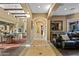 Spacious hallway with tiled flooring, beamed ceilings, and views into the living and dining areas at 37440 N 104Th Pl, Scottsdale, AZ 85262