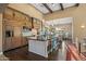 Gourmet kitchen featuring a large island with a wine cooler, custom cabinetry, and modern appliances at 37440 N 104Th Pl, Scottsdale, AZ 85262