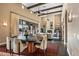 Open living area with dining table, stone fireplace, and large windows offering lots of natural light at 37440 N 104Th Pl, Scottsdale, AZ 85262
