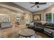 Cozy living room with tile and wood flooring, a large sectional, and an open layout at 37440 N 104Th Pl, Scottsdale, AZ 85262