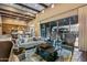 Spacious living room features wood beams, high ceilings, and large sliding doors to the backyard at 37440 N 104Th Pl, Scottsdale, AZ 85262