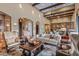 Beautiful living room featuring wood beams, natural light, and seamless flow into the kitchen area at 37440 N 104Th Pl, Scottsdale, AZ 85262