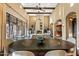 Beautiful open-concept living area with stone fireplace, wood beams, and dining table at 37440 N 104Th Pl, Scottsdale, AZ 85262