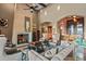 Warm and inviting living room featuring a stone fireplace, high ceilings, and arched doorways at 37440 N 104Th Pl, Scottsdale, AZ 85262