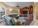 Inviting living room with a large sectional couch, a ceiling fan, and custom built-in shelving at 37440 N 104Th Pl, Scottsdale, AZ 85262