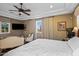 Spacious primary bedroom features a large bed, sitting area, television, and an outside view at 37440 N 104Th Pl, Scottsdale, AZ 85262