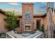 Inviting outdoor area with a brick fireplace, comfortable seating, and manicured landscaping at 37440 N 104Th Pl, Scottsdale, AZ 85262
