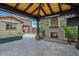 Inviting covered patio featuring an outdoor kitchen, fireplace, and a large TV, perfect for entertaining and relaxing at 37440 N 104Th Pl, Scottsdale, AZ 85262