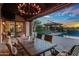 Stunning outdoor pool area with a covered patio, fireplace, and ample seating for entertaining at 37440 N 104Th Pl, Scottsdale, AZ 85262
