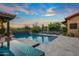 The backyard features a luxurious pool, spa, plenty of lounge chairs, and privacy from mature landscaping at 37440 N 104Th Pl, Scottsdale, AZ 85262