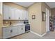Well-appointed wet bar featuring custom white cabinets, sink, beverage cooler, and microwave at 37440 N 104Th Pl, Scottsdale, AZ 85262