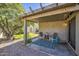 Relaxing covered back patio with comfortable seating and a view of the landscaped backyard at 3790 W White Canyon Rd, San Tan Valley, AZ 85144