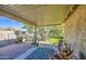 Relaxing covered back patio with seating area overlooking a well-kept garden at 3790 W White Canyon Rd, San Tan Valley, AZ 85144