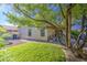 A landscaped backyard features desert landscaping, a small fire pit, and patio area shaded by a mature tree at 3790 W White Canyon Rd, San Tan Valley, AZ 85144