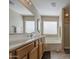 Well-lit bathroom with double sinks, soaking tub, and a separate shower with tiled floor at 3790 W White Canyon Rd, San Tan Valley, AZ 85144