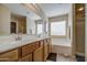 Bright bathroom with double sinks, ample counter space, and a shower stall with tiled flooring at 3790 W White Canyon Rd, San Tan Valley, AZ 85144