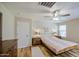 Light-filled bedroom featuring hardwood floors, modern fixtures, and a door to the other parts of the home at 3790 W White Canyon Rd, San Tan Valley, AZ 85144
