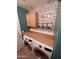 This laundry room features wood countertop, storage cabinets, stylish decorative wallpaper and a convenient side door at 3790 W White Canyon Rd, San Tan Valley, AZ 85144