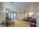 Spacious living room with wood floors, comfortable seating, and access to the backyard at 3790 W White Canyon Rd, San Tan Valley, AZ 85144