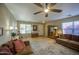 Inviting living room with a ceiling fan, natural light, wood floors, and comfortable furnishings at 3790 W White Canyon Rd, San Tan Valley, AZ 85144